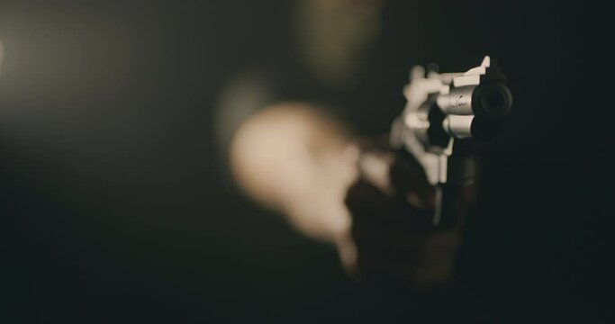 Masked man aiming a revolver