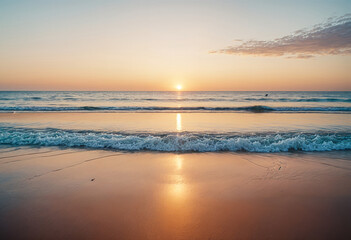 a sunset is reflected over the ocean with waves on the beach
