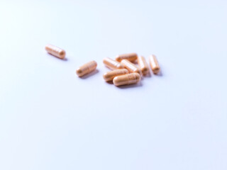 Lutein capsules. Dietary supplement on bright paper background. Soft focus. Close up. Copy space.	