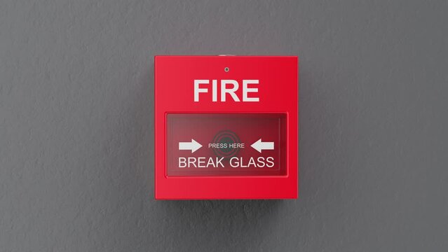 Fire alarm button on grey wall
