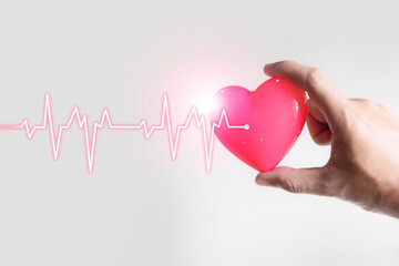 heartbeat with shape of heart in hand , medical examination concept