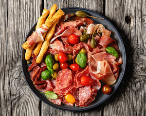italian antipasto plate of cured meat and veggies