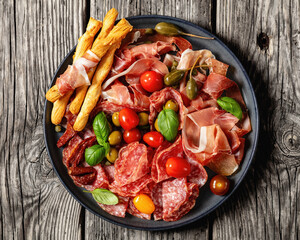 italian antipasto plate of cured meat and veggies