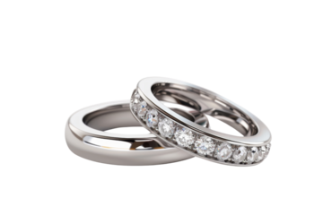 Close-up of two elegant silver wedding rings, one adorned with sparkling diamonds, isolated on a transparent background.