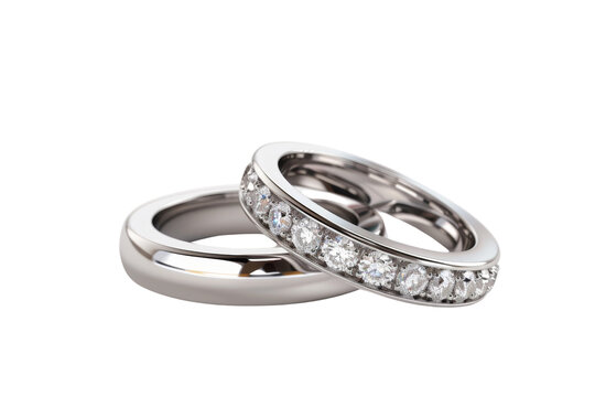 Close-up of two elegant silver wedding rings, one adorned with sparkling diamonds, isolated on a transparent background.
