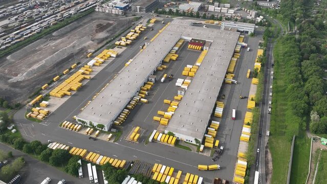 Aerial hyperlapse, time lapse video of a package sorting and distribution center. Logistics by road. Trucks moving dynamics.