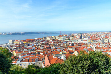 panoramic photo of the cityscape of Lisbon and the Tagus river on a sunny day