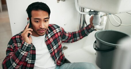 Frustrated man, plumbing and phone call with problem, leak or mistake on DIY, maintenance or repair by sink at home. Male person or handyman talking on mobile smartphone with issue or leakage by pipe