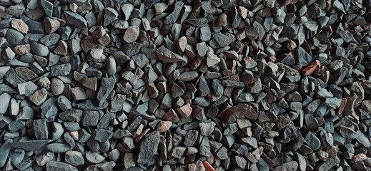 Crushed rock close up. Stone road building material gravel texture, background.