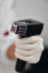 A woman receives Rf-lifting in a beauty salon.