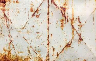 Metal wall painted white. Metal background with streaks of rust. There are rust stains on the metal surface.