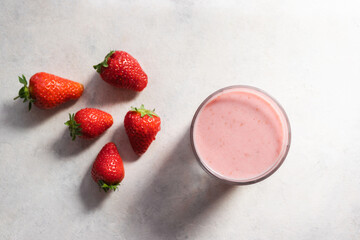 Strawberry smoothie drink, blended cocktail, milkshake in a glass, top view