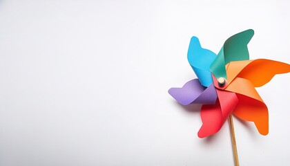 pinwheel or windmill paper origami isolated on white background simple starter craft for kids for weekend entertainment. ESG and Clean Energy Concept. Wind Turbine Paper into the Sky. Decrease Carbon