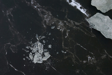 Lumps of alum on a black background. It is a mineral with clear, white crystals, odorless,...