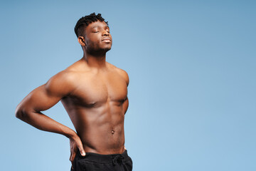 Authentic, sexy, African American man with bare muscular, pumped torso with closed eyes