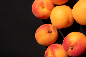 apricots on a black background. Summer fruit. Natural background