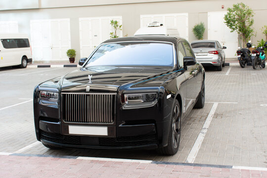 Luxury black Rolls Royce car in the street in Dubai City, UAE