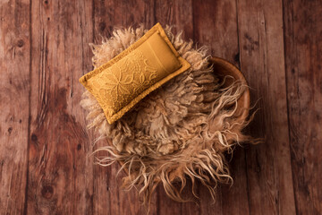 Basket with beige fur for a newborn photo shoot. Basket with cushion. Beige color. Background for newborn.