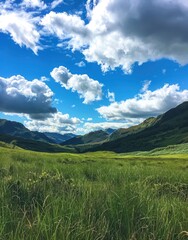 Fototapeta premium Majestic Scottish Highlands A Serene Green Valley under a Blue Sky