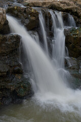 Water flowing between the rocks, beautiful water panorama, waterfall