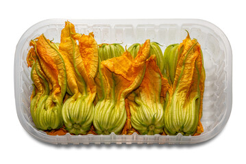 Zucchini flowers in plastic food tray isolated