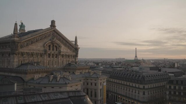 A stunning March sunset in Paris from the rooftop of Galeries Lafayette Haussmann, with the iconic Eiffel Tower towering among the city buildings.
