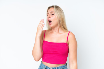 Young caucasian woman isolated on white background yawning and covering wide open mouth with hand