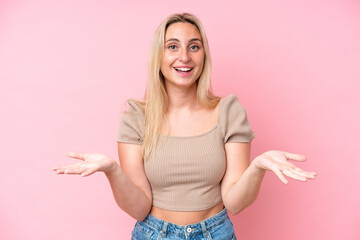 Young caucasian woman isolated on pink background with shocked facial expression