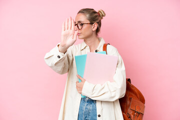 Young student caucasian woman isolated on pink background making stop gesture and disappointed