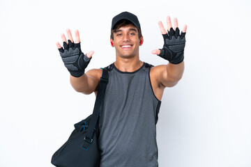 Young sport caucasian man with sport bag isolated on white background counting ten with fingers