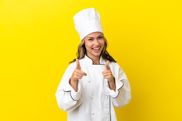Young Russian chef girl isolated on yellow background pointing to the front and smiling
