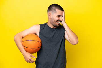 Young caucasian basketball player man isolated on yellow background smiling a lot
