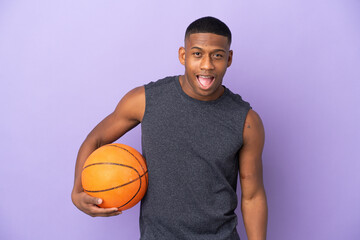 Young basketball latin player man isolated on purple background with surprise facial expression