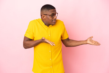 Young latin man isolated on pink background with surprise facial expression