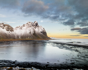 Snow-covered Vestrahorn mountain and icy landscape at Stokksnes beach, South East Iceland