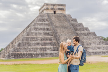 mother, father and and their son baby observing the old pyramid and temple of the castle of the Mayan architecture known as Chichen Itza these are the ruins of this ancient pre-columbian civilization