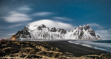 Stunning night view of snow-covered Vestrahorn mountains at Stokksnes beach, South East Iceland