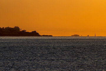 Mediterranean Sea with calm waters illuminated by the first lights of dawn, creating reflections...