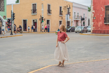 Woman tourist explores the vibrant streets of Valladolid, Mexico, immersing herself in the rich...