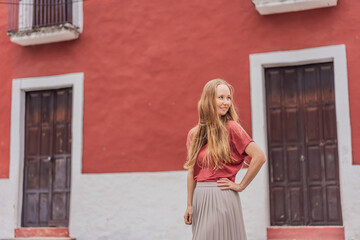 Woman tourist explores the vibrant streets of Valladolid, Mexico, immersing herself in the rich...