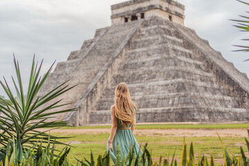 Beautiful tourist woman observing the old pyramid and temple of the castle of the Mayan...
