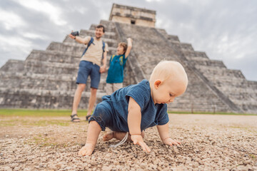 Father and two sons tourists observing the old pyramid and temple of the castle of the Mayan...