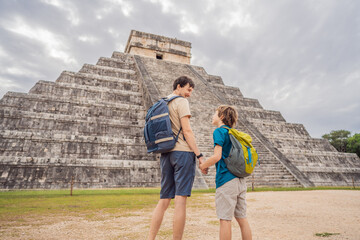 Father and son tourists observing the old pyramid and temple of the castle of the Mayan...