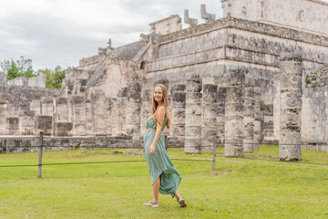 Beautiful tourist woman observing the old pyramid and temple of the castle of the Mayan...