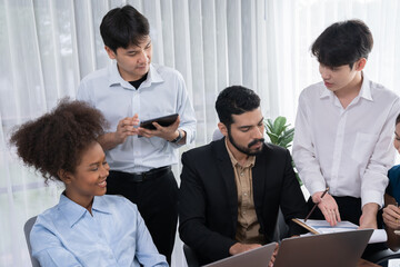 Happy diverse business people work together, discussing in corporate office. Professional and diversity teamwork discuss business plan on desk with laptop. Modern multicultural office worker. Concord