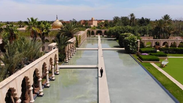 people walking near the water, Namaskar Palace, a luxurious oasis in Marrakech, Morocco