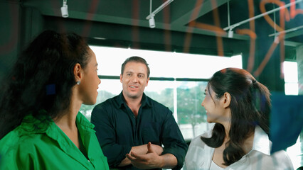 Portrait of professional diverse business team brainstorming marketing idea on colorful sticky...