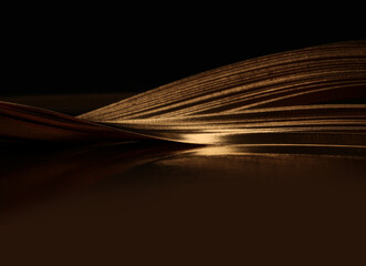 Abstract glow backgound. Gold (bronze) paper wave line on black reflection light and shadow background.