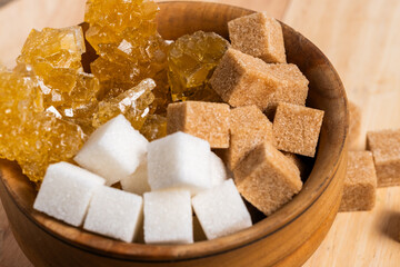 Traditional Uzbek navat sugar, cane sugar and refined sugar in wooden cup.