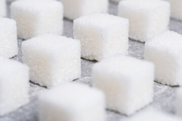 Refined sugar cubes are laid out in clear geometric lines.
